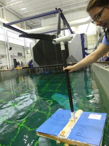 Photo of a student testing a floating wind turbine platform