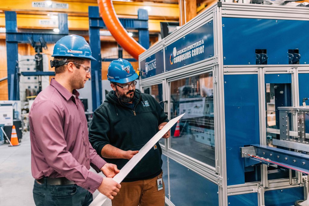 ASCC engineers inspecting a thermoplastic material in front of the continuous forming machine