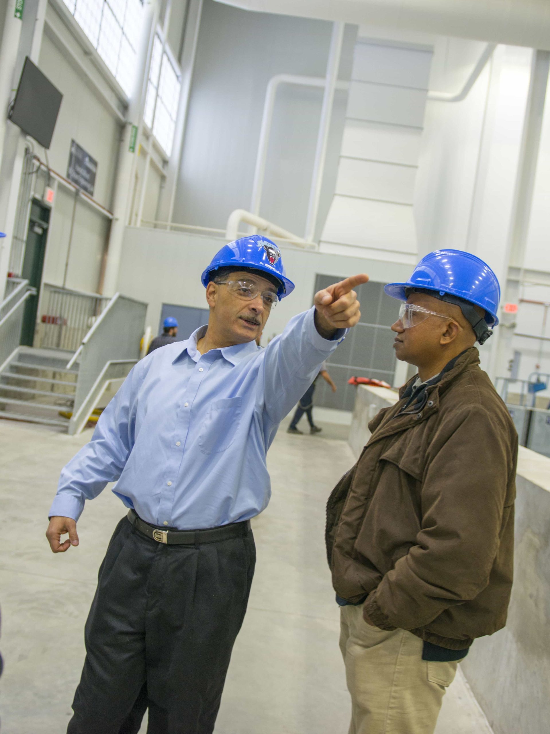 Dr. Habib Dagher pointing to something next to Alfond W2 Basin