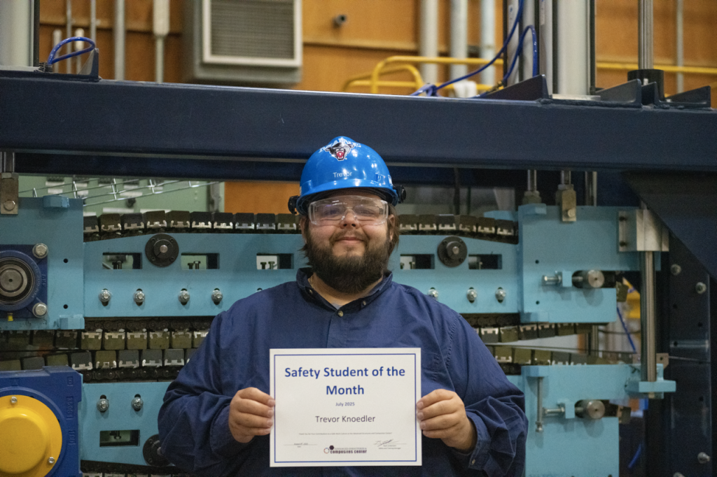Trevor Knoedler holding up Safety Student of the Month certificate